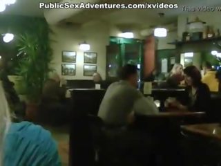 Blonde young female showing tits in the cafe