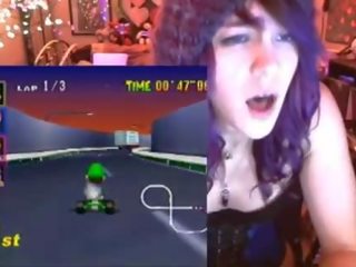 Geek young woman cums playing Mario Kart