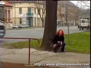 Nubile redhead taking a piss in a public park